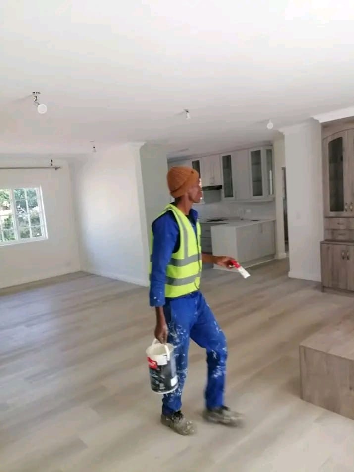 Painter finishing the interior of a home renovated by Phuda Construction